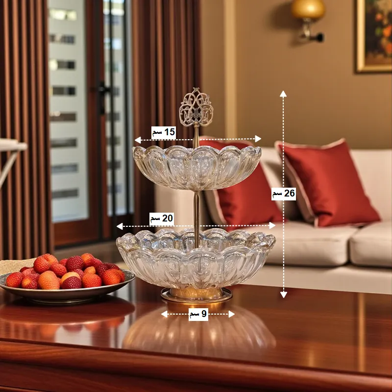 أبعاد شيالة كريستال بطابقين: الارتفاع الكلي 26 سم، قطر الطبق العلوي 15 سم، قطر الطبق السفلي 20 سم، وقطر القاعدة 9 سم.