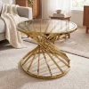 ترابيزة ضيافة بتصميم عصري من الستانلس ستيل باللون الذهبي اللامع وسطح زجاجي عسلي معروضة داخل غرفة معيشة أنيقة.